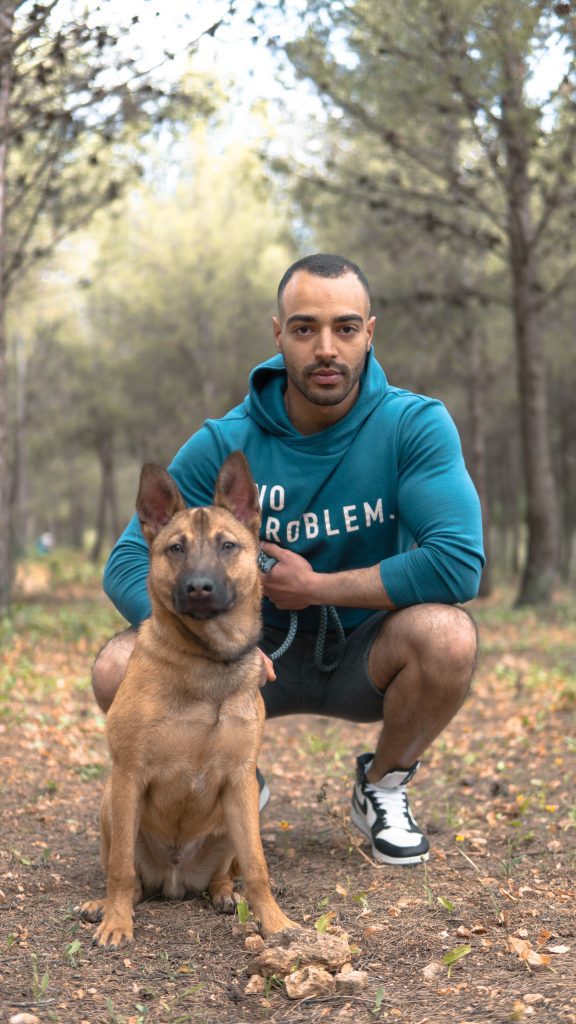 Photo by Ilyas Chabli: https://www.pexels.com/photo/a-dog-beside-his-trainer-on-a-forest-7596832/